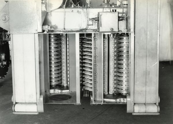 Engineering photograph focusing on the spindles of an experimental single-row, two drum staggered cotton picker.