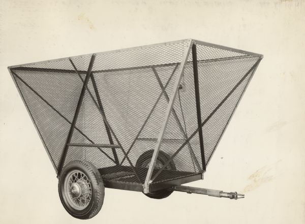 Engineering photograph of an experimental two-wheeled cotton trailer, designed for use with a cotton picker.