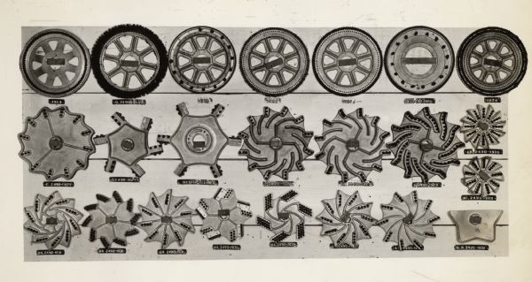 Engineering photograph of metal parts lined up to illustrate "general changes in (the) past several years" during the development of the cotton picker.