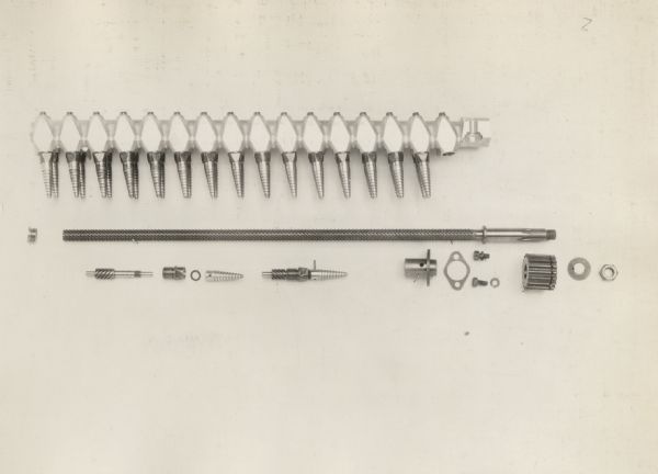 Engineering photograph of an experimental cotton picker bar with 2-13/16" long saw tooth fingers.