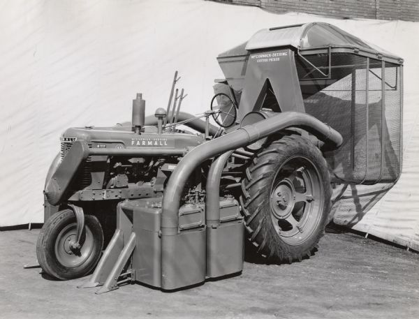 Engineering photograph of a 2-row cotton picker on a Farmall "H" tractor.
