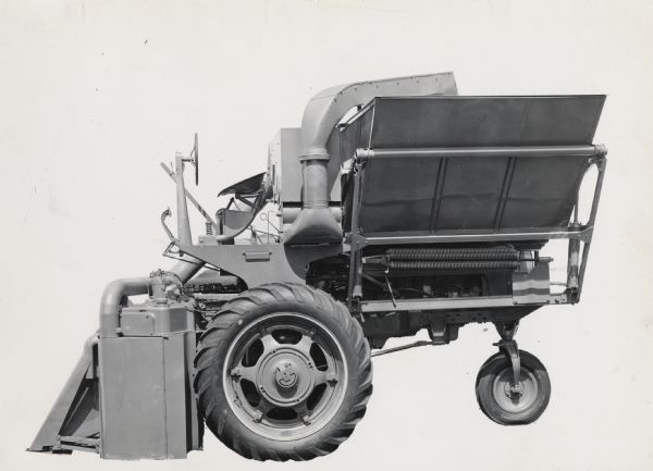 Engineering photograph of the left side of an experimental cotton harvester [picker].