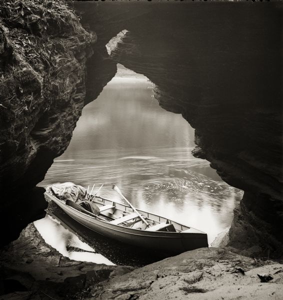 Bass Cave, looking out to river and rowboat.