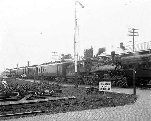 A train on the tracks at the Corliss Depot. There is a sign in front of it that reads "This Train For Chicago".