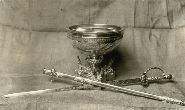 Studio photograph of a silver punch bowl and a silver sword presented to Civil War General Joseph Bailey in commemoration of the dam he built on the Red River near Alexandria, Louisiana, creating enough water flow to allow the Union ironclad fleet to escape Confederate capture.