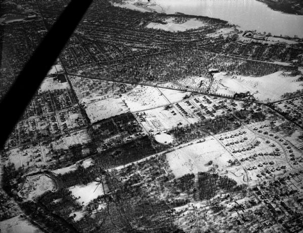 Looking southeast across Speedway Road. Visible are the reservoir on Glenway Street, Hoyt Park, Resurrection and Forest Hill cemeteries, Glenway Golf course, Vilas Park, Camp Randall stadium. Other major streets are Regent Street, Monroe Street, and Mineral Point Road. There is snow on the ground.