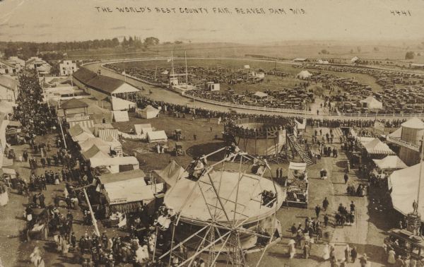 Elevated view of the county fair, including Ferris wheel and horse racetrack. Caption reads: "The World's Best County Fair, Beaver Dam, Wis."