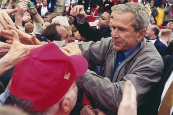 President George W. Bush greets a crowd during a campaign stop in La Crosse at Copeland Field.