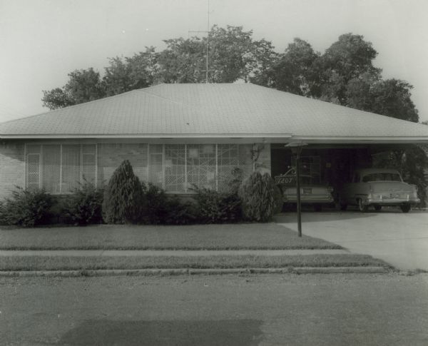 The Little Rock home of Daisy and L.C. Bates, showing their front window after a stone had been thrown through the window. Grates have been placed on this and other windows in order to prevent further damage. This event, which took place before the integration crisis began in September, was an indication that integration would not take place peacefully. The Bates continued to be the target of racial harassment because of Daisy's leadership in the integration effort.