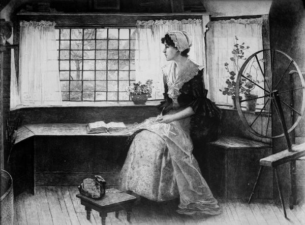 Woman in a dress and bonnet seated on a bench at a window with a book (The Bible?) open in front of her. There is a spinning wheel in the corner behind the woman.