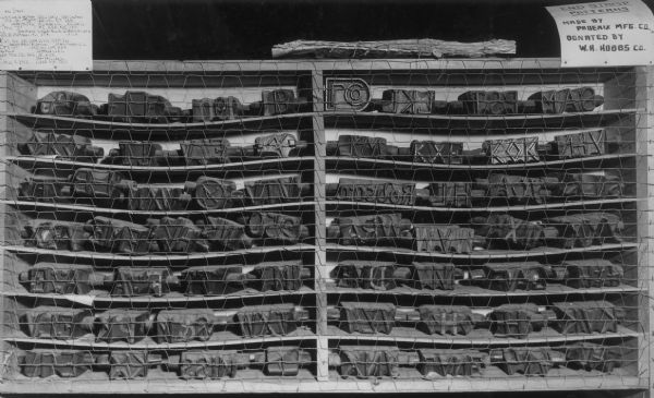 A collection of end stamp patterns used to identify the owners of logs, as exhibited in the Paul Bunyan Camp Museum in Carson Park.