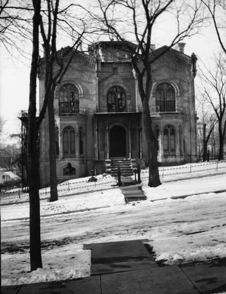 The McDonnell-Garnhart residence, 424 North Pinckney Street.  This Romanesque revival house was designed in 1857 by Samuel H. Donnel, the architect for the third Wisconsin Capitol, for contractor Alexander A. McDonnell. The latter used the same Prairie du Chien sandstone that was employed in building the Capitol, a project for which he also served as a contractor that year. McDonnell's residence is sometimes referred to by the surnames of its subsequent owners: Pierce, Garnhart, and Conover.
