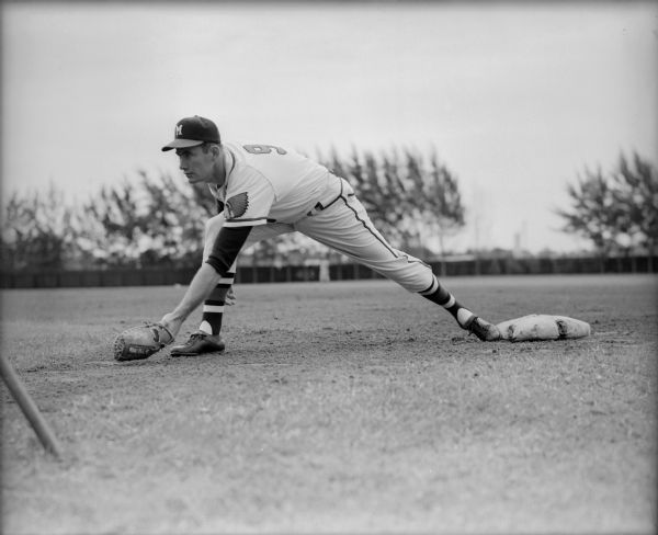 Milwaukee Braves player Joe Adcock fields a ball during spring training.