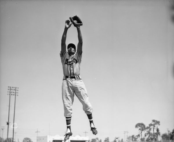 Milwaukee Braves player William 'Billy'  Bruton fields a fly ball during spring training.