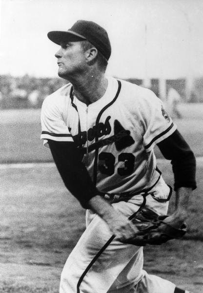Milwaukee Braves player Lew Burdette in play during a ball game.
