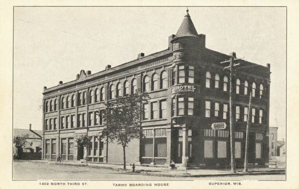 View across street toward the Hotel Tarmo, a boarding house. Caption reads: "1402 North Third St., Tarmo Boarding House, Superior, Wis."