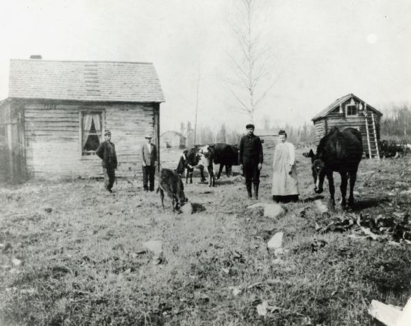 Family posed outdoors at a farm in Northern Minnesota or Michigan.