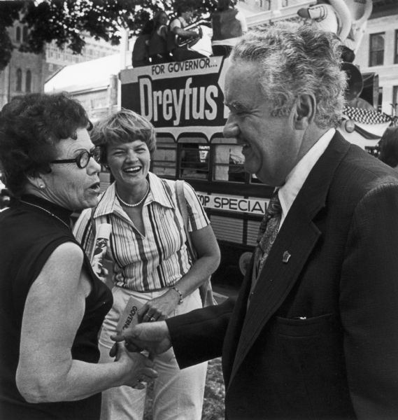 Campaigning for Governor in Madison, Lee Sherman Dreyfus shakes hands with a few passersby.