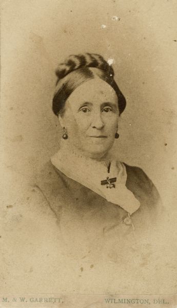 Studio portrait of Susan Whitham Bouldin Clark, wearing earrings.