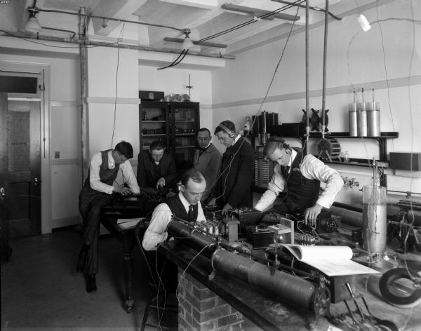 In preparation for military service, young men at the University of Wisconsin study radio operations.