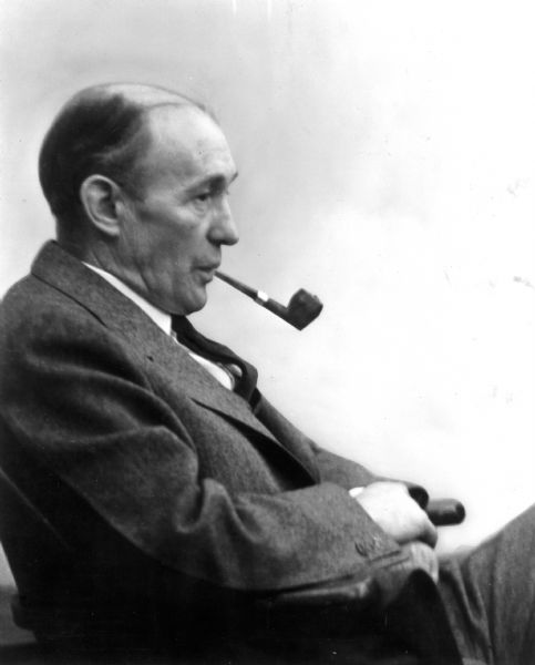 Candid view of Arthur W. Page wearing a business suit and smoking a pipe.