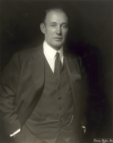 Studio portrait of Arthur W. Page wearing a suit, with his hands in his pockets.