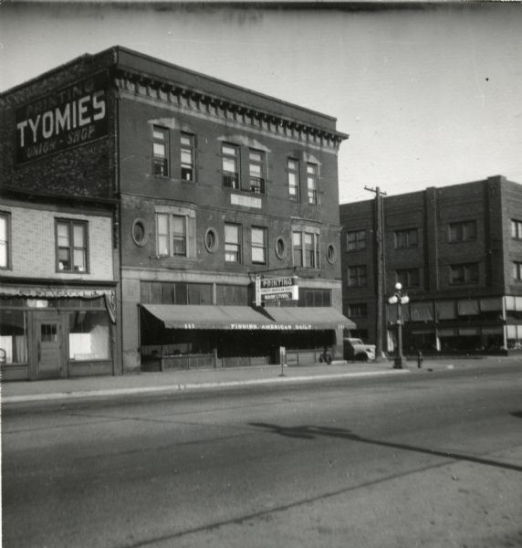 Exterior view of the Tyomies Publishing Company building. The 6th Street Cafe is visible next door.