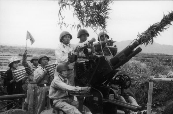 Anti-aircraft crew that was said to have downed 14 American planes during four days in December, 1965. This propaganda photograph was released by a Hanoi source on June 1, 1966, and it was received by the National Coordinating Committee Against the War in Vietnam for use in its newsletter.