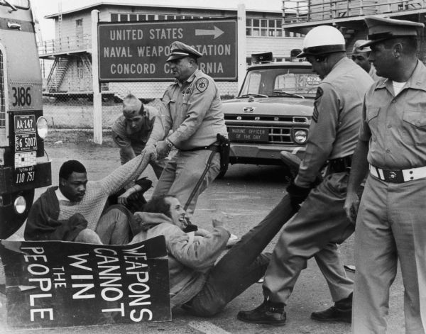 Anti-Vietnam War protestors being dragged onto federal property by police at the Naval Weapons Station.