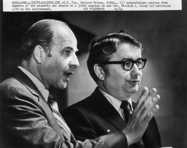 Wisconsin Senator Gaylord Nelson acknowledges the applause of the Wisconsin Legislature at an event held in the Wisconsin State Capitol to mark the second Earth Day. With Nelson is Wisconsin Governor Patrick J. Lucey.