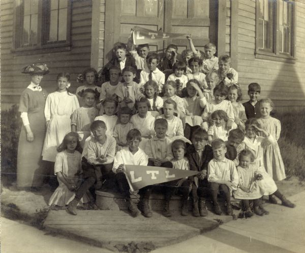 A group of Wisconsin Loyal Temperance League children and their teacher.  The LTL was a branch of the Women's Christian Temperance Union that focused on the education of young children, and the Wisconsin league was formed during the 1880s.