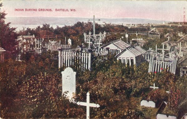 Indian cemetery. A large body of water is in the background. Caption reads: "Indian Burying Grounds, Bayfield, Wis."