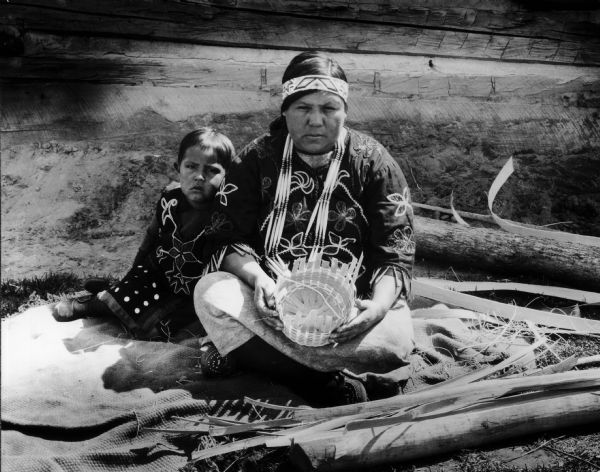 Indian basket maker with her child.