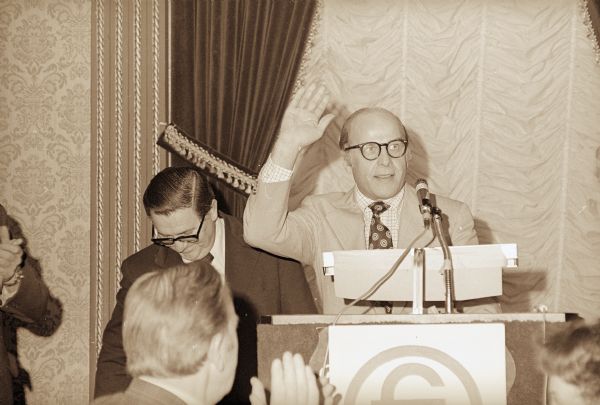 During a speech at an agricultural conference in Milwaukee, Senator Gaylord Nelson acknowledges applause from the audience.