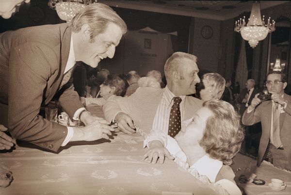Senator Walter Mondale of Minnesota was a featured speaker at an agricultural conference in Milwaukee in 1974.  At the time he was exploring the feasibility of running for president.  Eventually, however, he became the vice-presidential candidate on the Carter-Mondale ticket in 1976.  Here, he signs an autograph for an admiring Wisconsin voter.