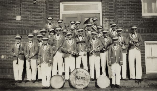 The band poses for a group portrait, most likely in front of a school building; the boys are dressed in uniform and are holding their instruments. Gaylord Nelson played the trumpet in the band and stands in the front row, third from the left.