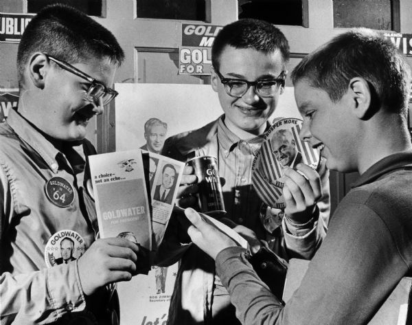Three young men displaying some campaign materials outside their own GOP headquarters in a garage at 8608 W. Meinecke Avenue in Wauwatosa. They are, from left to right: Dale Adomat, 11, Dean Smith, age 13, and Charles Armitage, age 11, all from Wauwatosa. The boys have distributed buttons and literature door-to-door.
