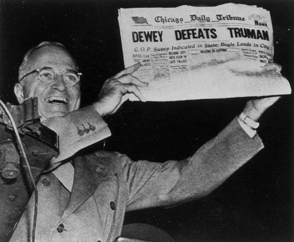President Harry S. Truman holds up the newspaper which has the headline that mistakenly reports "Dewey Defeats Truman".