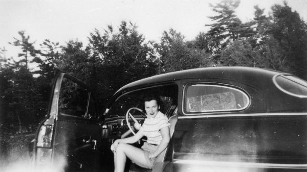 Portrait of Pela Rosen Alpert in the car of her future husband, Richard Alpert.