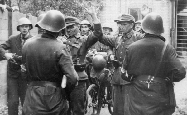 Members of Dutch Underground arresting a German soldier on the day of liberation in Amsterdam.