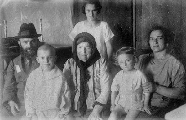 Lucy (Rothstein) Baras' family portrait (from left): Wolf (Mrs. Baras' father), Joe (her brother), Rifke Feige (her grandmother), Lucy (standing), Milo (brother), Gusta (her mother); Skalat, Poland.