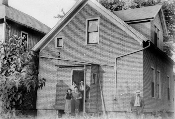 From left: Lucy Baras, Sylvie Baras (sister-in-law), Edward Baras (husband), Fishel Gelbtuch (Sylvie's father); Baras residence.