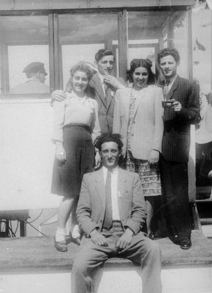 Foreground: Sasha Auerbach (brother of Esther Chulew). Back, from left: unidentified woman, Manny Chulew, Esther Chulew (sister-in-law), Baruch Chulew (brother); Linz, Austria.