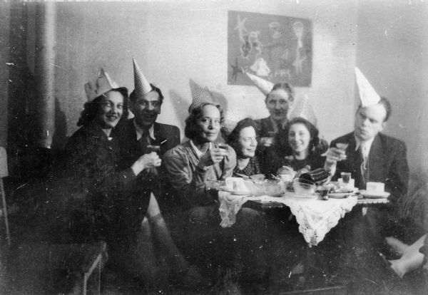 New Year's Eve party at Deutschkron apartment. Eva Lauffer Deutschkron second from left in foreground, Martin Deutschkron is at far right; Berlin.