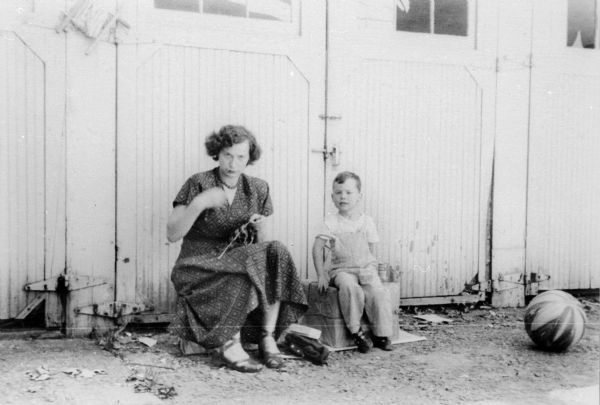 Eva Lauffer Deutschkron and son, Edward, sitting in front of their apartment; 2127 University Avenue.