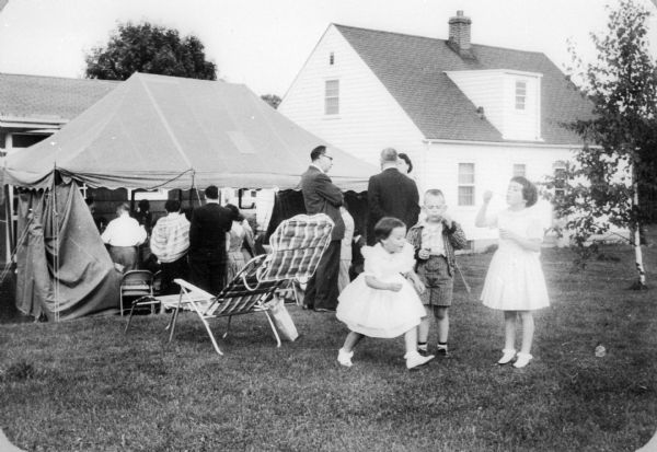 Party in honor of Edward (son of Eva Lauffer Deutschkron), Deutschkron's Bar Mitzvah, at Deutschkron's. Children, from left: Debbie Stern (cousin), Bruce Wood, Ruth (sister).