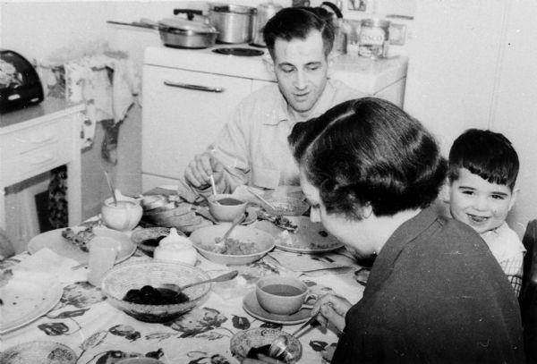 Rosa Goldberg Katz, Bernard, and Arthur Katz dining in their home.