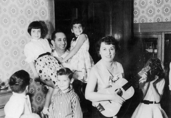 Family gathering for the visit of aunt Miriam and Ben Seiden to Milwaukee. Salvator Moshe is holding Mathilde (left) and niece, Cookie Seiden (right).  Front row (from left): son Michael Moshe, nephew Marc Seiden, and unidentified girl.