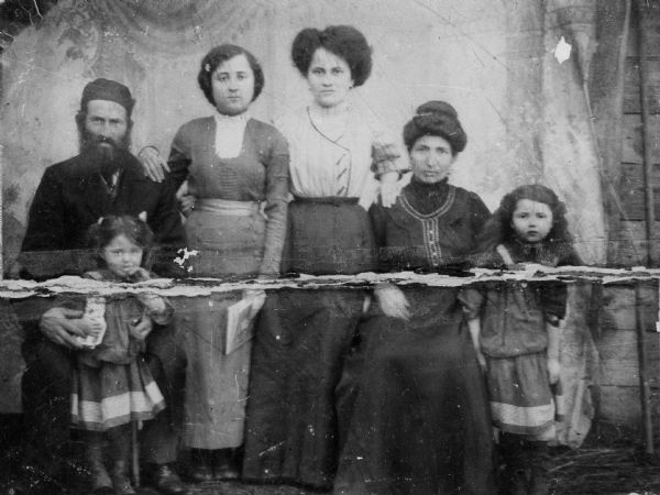 Group portrait of the Gahr Tine family (relatives of Holocaust survivor Cyla Tine Stundel). Cyla Tine Stundel's mother is Golden Gahr Tine. Back row (from left): Grandfather Yankel Gahr, aunt Charna Gahr, Golden Gahr Tine, grandmother Frume Gahr, sister Marim Tine. Front row: sister Perl Tine (holding a cat). Dubno, Poland.