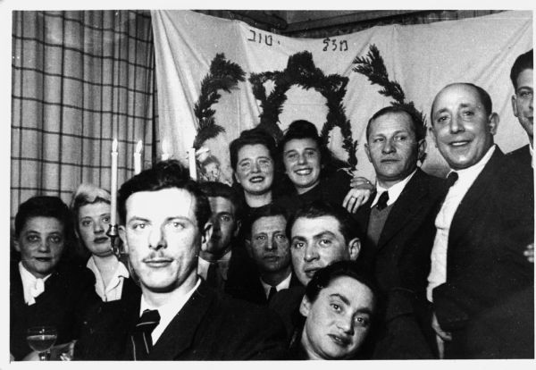 A self-portrait by Walter Wolf Peltz (foreground) at a party with a group of Jewish Holocaust survivors who called themselves "The Club"; Germany.